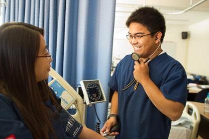 nursing student takes blood pressure of other student